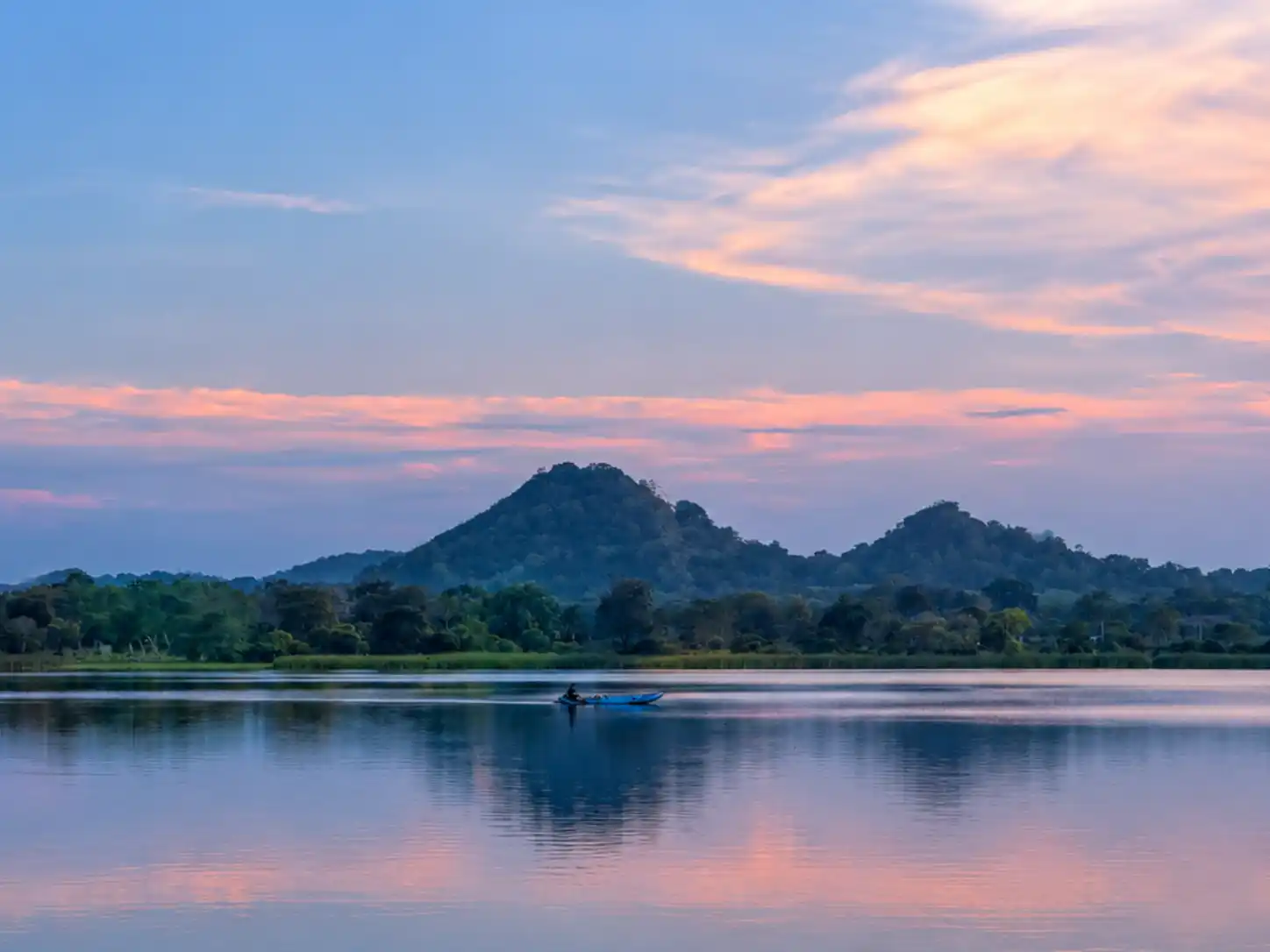 A peaceful reservoir at sunset near Mailagama